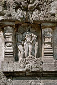 Prambanan - Candi Lara Jonggrang, miniature shrines surmounted by small fluted stupa with panels with musicians and dancers decorating the top of the balustrade 